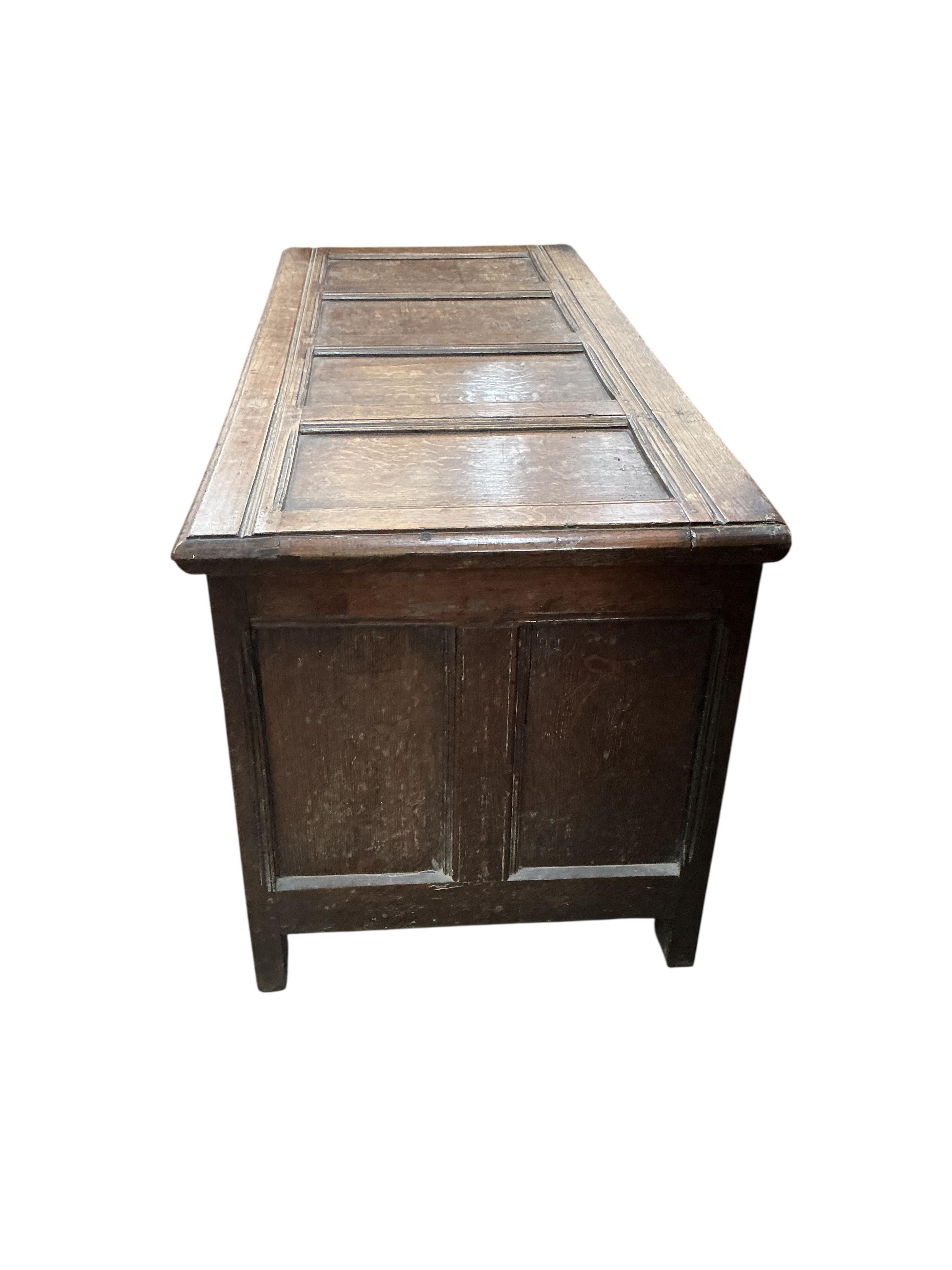 An 18th century panelled oak coffer, width 130cm, depth 55cm, height 61cm